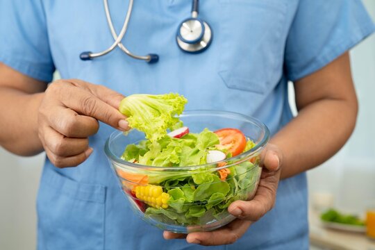 Asian Nutritionist holding healthy food for patient in hospital, nutrition and vitamin.