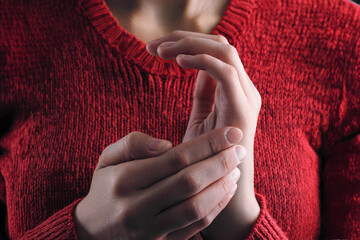 Person in red is tapping karate chop point practicing EFT .