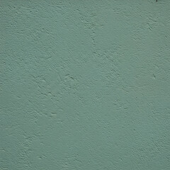 Fototapeta premium Plain teal stucco wall texture showing a uniform, textured surface. A close-up view of the wall's surface texture and color. Architectural backdrop. Exterior building material -
