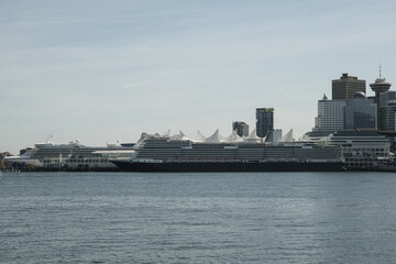 Obraz premium Modern luxury cruiseship cruise ship liner Koningsdam, Nieuw Statendam or Rotterdam departure sail away from Vancouver BC port, Canada for Alaska cruise with breathtaking nature landscape scenery