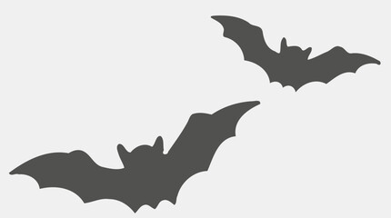 Two bats, silhouettes against a light background.

