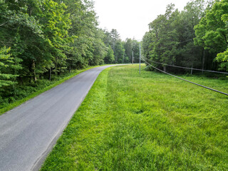aerial view of empty road in the hudson valley farm rural suburban power line electrical wires nobody travel drive beautiful