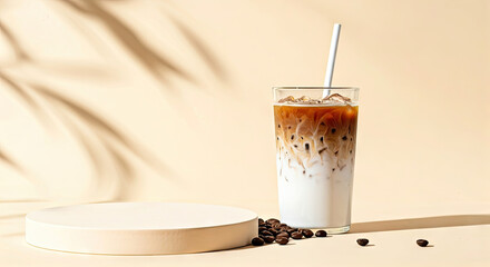Iced Latte in Glass with Coffee Beans on Cream Background