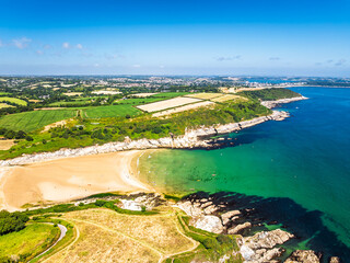 Cliffs over Maenporth Beach and Stack Point from a drone, Falmouth Bay, Falmouth, Cornwall, UK