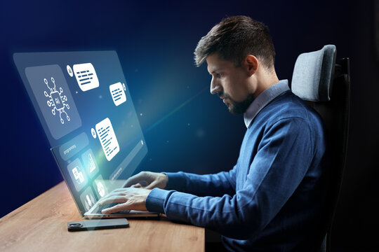 Young professional working on futuristic computer interface with holographic display in modern office setting