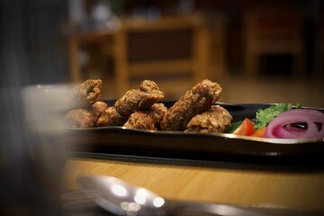 Seekh kebab in a restaurant background served in black plate
