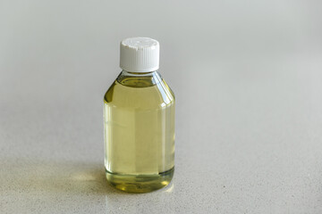 Clear Plastic Bottle of Mineral Oil on Light Countertop Surface