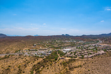 Beeline Highway winding through desert landscape of Maricopa County, Arizona development residential areas Mountains rise roadway surrounding desert American Southwest.