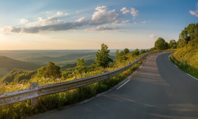 Fototapeta premium Scenic winding road through rolling hills at sunset