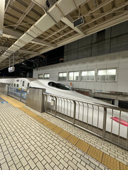 Japanese Shinkansen Bullet Train at Station Platform at Night
