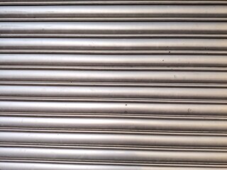 Obraz premium Roller door or roller shutter texture consist of steel slat in horizontal for background about industry, security, safety, architecture. Abstract metal horizontal line or texture. 3D render.