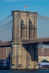 Fototapeta premium Brooklyn Bridge Stone Tower with American Flag in New York City 