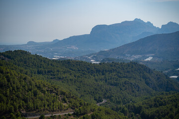 Fototapeta premium Winding road through serene mountains and forest in Spain