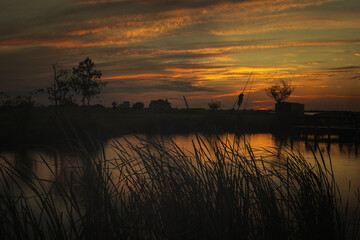 Horizontal Color image of a Sunset on over a pond near Rockport, TX.  