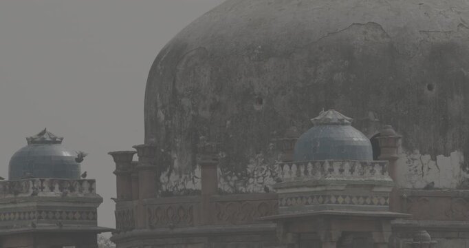 New Delhi, Delhi, India. Doves birds flying above Babur's Tomb near The Humayun's tomb. Famous place is Tomb of Mughal emperor, Mirza Nasir al-Din Muhammad commonly known as Humayun situated in Delhi