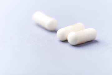 Creatine tablets on paper background. Soft focus. Close up. Copy space.	