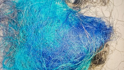 close-up of tangled fibers or threads, appearing in shades of blue and green. close-up of tangled fibers or threads, appearing in shades of blue and green. , different shades of fibers, different shad