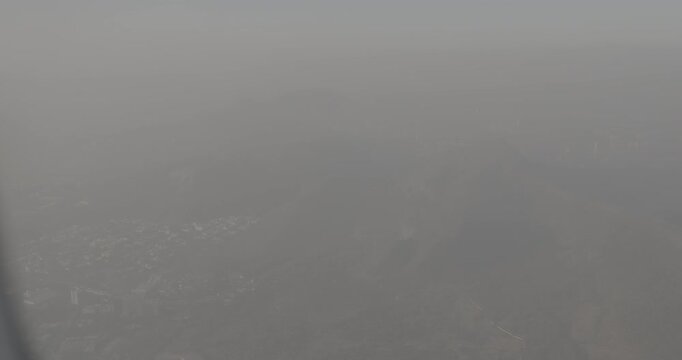 Shil Phata - Mahape Rd, MIDC Industrial Area, Mahape, Navi Mumbai, Maharashtra, India. Mumbai Metropolitan Region. Aerial View From Airplane Window On View of the Mumbai suburb district. Evening