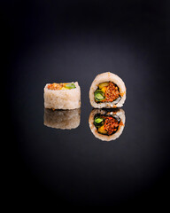minimalist and elegant studio shot of an inside-out sushi roll (uramaki) or Gimbap variation, sliced in two and placed on a reflective black surface. The vibrant filling is visible through the outer l