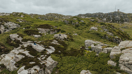 Fototapeta premium Rocky Landscape with Vegetation and Communication Tower in Norway
