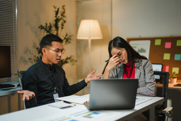 Business colleagues arguing during a late night meeting in the office