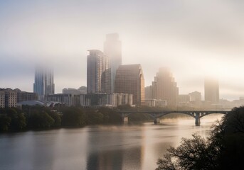Fototapeta premium Misty Morning Over Austin: Skyscrapers Shrouded in Fog with Serene River