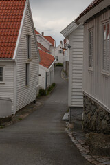 Narrow Street with White Wooden Houses in a Norwegian Coastal Town