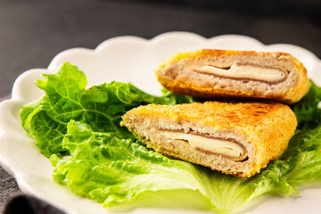 Cutlet cordon bleu meat chicken, cheese, ham second course french cuisine tasty snack fresh delicious gourmet food background on the table rustic food top view copy space