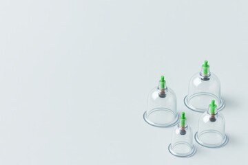 Clean glass cupping therapy cups on a light background. Traditional Chinese medicine tools for alternative healing. Hijama, treatment according to the Sunnah.