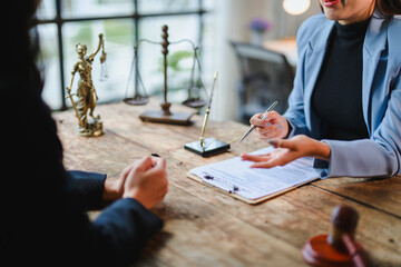 Lawyer explaining contract details to client during meeting in office