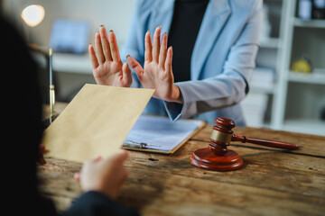 Lawyer refusing bribe offered by client in courtroom during legal proceedings