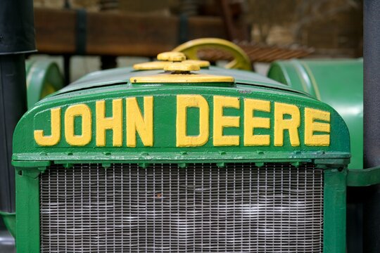 Vintage John Deere tractor grille with yellow emblem lettering