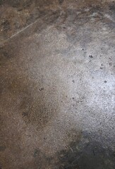 A gray footprint in the sand with a rough, textured, grunge pattern of old concrete and rock