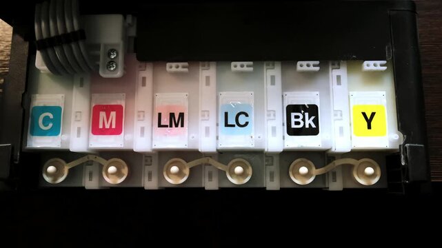 Digital inkjet printer with 6 colors of continuous ink supply system in home office printer. Print paints. CMYK system. Black yellow light magenta and cyan. High quality 4k footage.