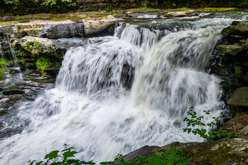 Fototapeta premium Rushing Water Of Dunloup Creek Splashes Over A Waterfall