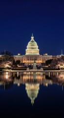 Illuminated Capitol Building at Night with Reflective Pond in the Foreground