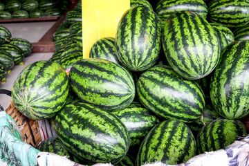 Many ripe sweet watermelon on sell at Asian local market. Tropical fresh juicy   delicious fruit