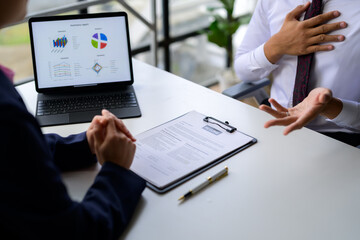 Business people discussing resume and summary report during job interview