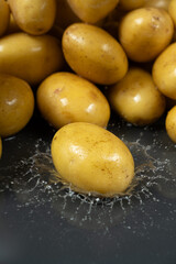 Whole fresh unpeeled potatoes in a splash of water.