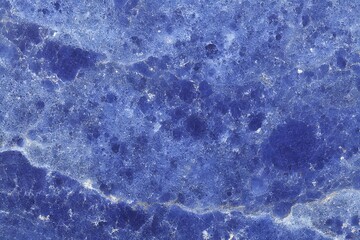 Macro shot of a stunning blue marble texture, showcasing intricate patterns and a polished surface
