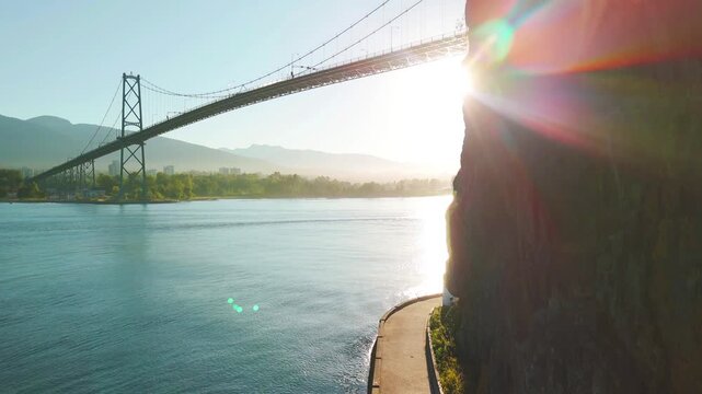 ascending aerial view of a bridge over a bay near Vancouver shore
