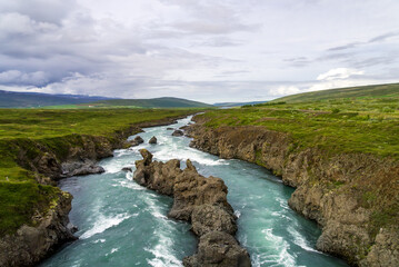 River Skjalfandafljot flowing away from Godafoss near Akureyri in Northern Iceland is a popular tourist attraction
