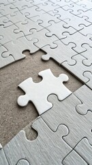 Obraz premium A single white puzzle piece is about to be placed into a missing spot
