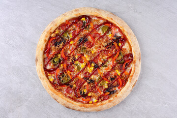 Spicy pizza topped with jalapenos, pepperoni, corn, red peppers, crispy onions, and drizzled with barbecue sauce