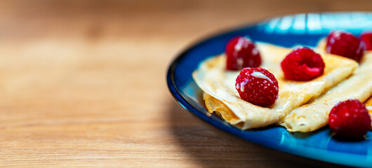 Pancakes with raspberries and condensed milk.