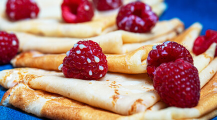 Pancakes with raspberries and condensed milk.