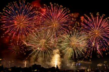 Firework display off the beach of Juan les Pins in the south of France, above boats moored close to shore.