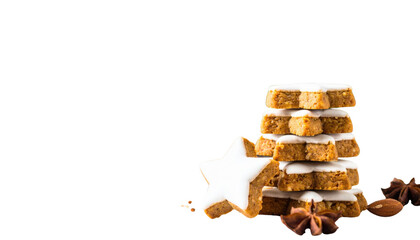 A stack of star-shaped cookies topped with icing, accompanied by spices, presenting a festive and appetizing appearance.