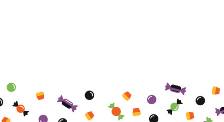 A scattering of Halloween candy including corn, wrapped sweets, and round candies.