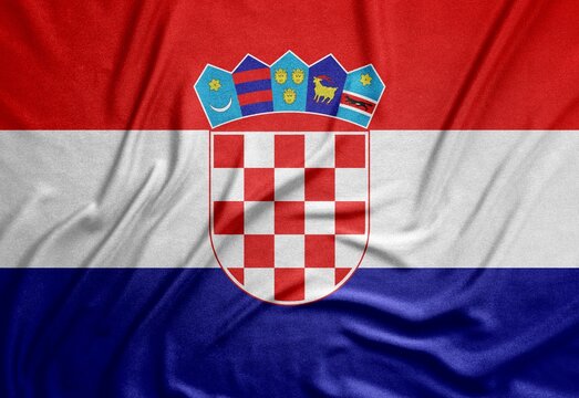 tricolor flag of the European country Croatia with a beautiful coat of arms on a rough canvas with folds and shadows